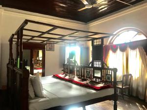 a bedroom with a large bed in a room at Ballard Bungallow in Cochin