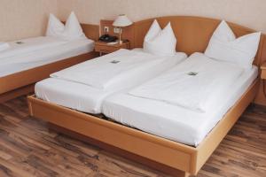 Postel nebo postele na pokoji v ubytování Flair Hotel Grüner Baum