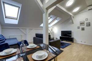 a living room with a dining table and a couch at Spacious Old Town LOFT for 6 in Bratislava