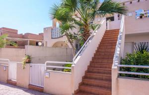 a staircase leading up to a house with palm trees at II Precioso apartamento con piscina y garaje II in Cuevas del Almanzora