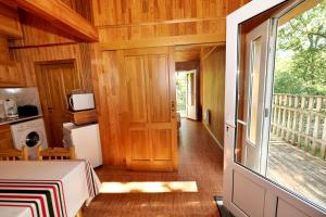 a room with a door leading to a balcony at Les Chalets Cobadena-Borda Pays Basque in Mouguerre