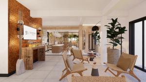 a lobby of a hotel with chairs and tables at Go Sun Beach Residence in Flic-en-Flac