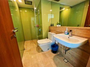 a bathroom with a sink and a toilet and a mirror at Vortex city view klcc in Kuala Lumpur