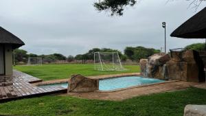 a pool with a soccer goal in a field at Eids Farm in Mmukubyane