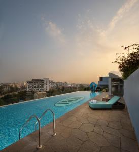 a swimming pool on the side of a building at Wow Crest, Indore - IHCL SeleQtions in Indore