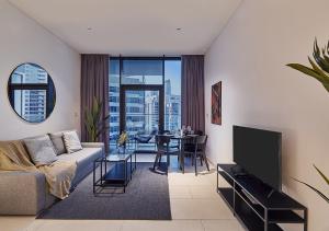 a living room with a couch and a table at Luxury Studios with Burj Khalifa or Canal View in Downtown - Marquise Square Tower in Dubai