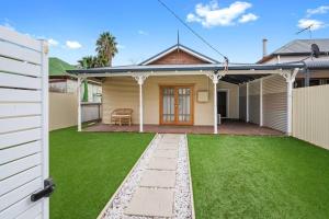 a house with a green lawn in front of it at Super House, Super Host in Kalgoorlie