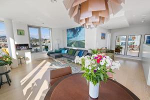 a living room with a vase of flowers on a table at Modern 2bed room sea view apartment @ Oslo Barcode in Oslo