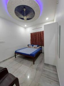 a room with a blue bed and a window at Entire Villa in Jodhpur