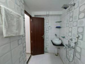 a bathroom with a sink and a shower in it at Entire Villa in Jodhpur