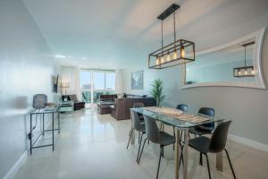 a dining room and living room with a table and chairs at OCEAN RESERVE - 15th Floor - Gorgeous Ocean View in Miami Beach