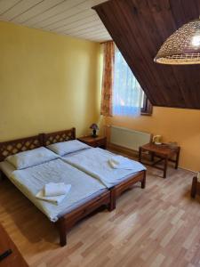 a bedroom with a bed and a large window at Hotel Autis in Vysoké Tatry