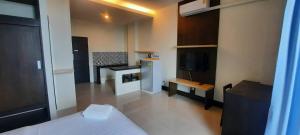 a small room with a bed and a tv in it at @Home Residence in Bang Kapi