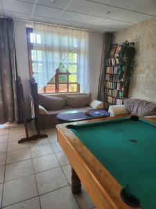 a living room with a pool table in it at Hotel Autis in Vysoké Tatry