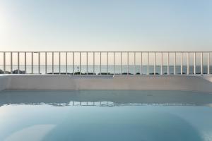 a pool of water with a fence in the background at Appartamenti Torre Bianca in Lignano Sabbiadoro