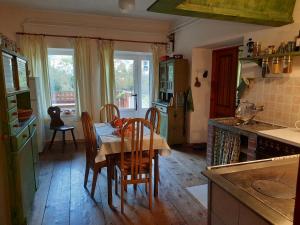 a kitchen with a table and chairs and a kitchen with a table and a table at Stara Hiša in Log Čezsoški