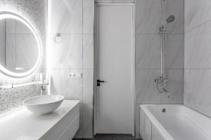 a bathroom with a sink and a tub and a mirror at Boulevard 181 in Tashkent +15 photos