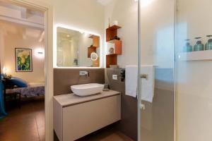 a bathroom with a sink and a mirror at B&B Hole6 in Castenaso