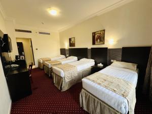 Postel nebo postele na pokoji v ubytování Miaad Al Majd Hotel