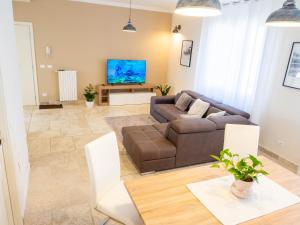 a living room with a couch and a table at Apartment with Beautiful Sun in Montepulciano