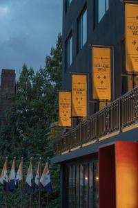 a row of flags on the side of a building at Nouvelle Seoul Hotel Itaewon in Seoul