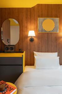 a hotel room with a bed and a mirror at Nouvelle Seoul Hotel Itaewon in Seoul