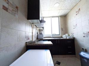 a small kitchen with a sink and a window at Al Badaa Star Residence - Home Stay in Dubai