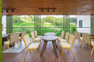 a dining room with a table and chairs on a deck at Die Pause Pool villa Pension in Gapyeong