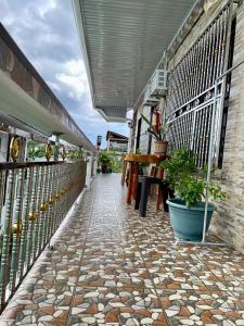 a walkway with a stone floor and a building at PEPAYEN INN Homestay in General Luna