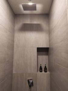 a bathroom with a shower with two bottles on a shelf at Ceylonz Suites, casa for your holiday in Kuala Lumpur