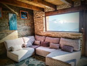 a living room with a couch and a window at Magic Borda Cremat HUT4-5018 in La Massana