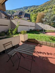 a bench sitting on top of a patio at Studio cosy Edelweiss in Luchon