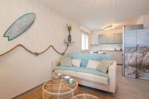 a living room with a couch and a table at Beach Resort - Casa Vostra - CAUTION 800 EUR & ID requises - Saint Julien Centre-Gare in Saint-Julien-en-Genevois +13 photos