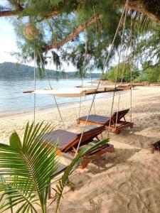 a swing on a beach with the ocean at The Beach Cafe in Ko Chang