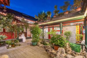 a building with potted plants in front of it at 北京悦明元星空白塔景观四合院民宿 in Beijing