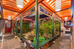 a large aquarium with plants in a building at 北京悦明元星空白塔景观四合院民宿 in Beijing