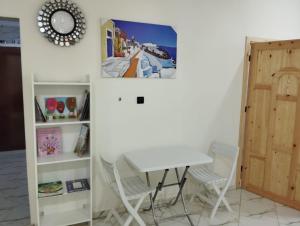 a room with a table and chairs and a door at AlMohit Larache in Larache