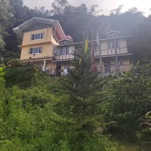 a house on the side of a hill at Oak valley retreat in Pelling