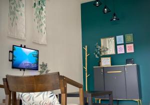 a living room with a tv and a chair at Modern Style Home, Pekan WIFI Netflix in Pekan