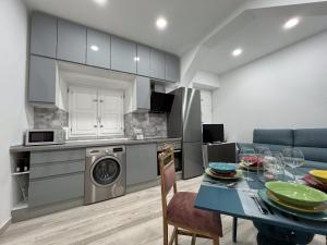 a kitchen and dining room with a table and a dining room at Redondilla in Madrid