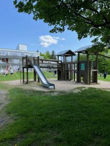 a playground with a slide in a park at Bavarian Escape Ferienwohnung mit Pool in Sankt Englmar