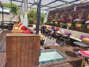 a patio with a pool and tables and chairs at 北京悦明元星空白塔景观四合院民宿 in Beijing