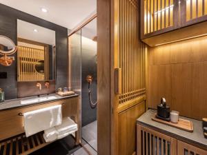 a bathroom with a sink and a shower at 北京悦明元星空白塔景观四合院民宿 in Beijing