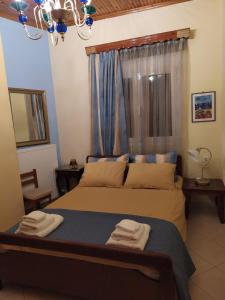a bedroom with a bed with two towels on it at Dora's Home in Pramanta