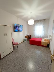 a bedroom with a red bed and a red chair at Domus Stadio in Pescara