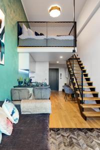 a living room with a loft bed and a staircase at Tempus Te Premium Duo Lofts Tartu - private cinema, gym and terrace in Tartu
