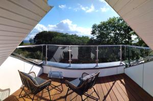 a balcony with two chairs and a table at Villa Eckhart in Göhren