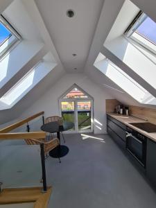 a kitchen with some skylights and a table and a counter at Villa Eckhart in Göhren