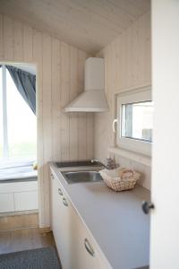 a small kitchen with a sink and a window at Charmante la petite maison in Potsdam