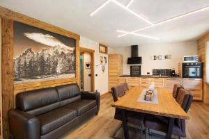 a living room with a couch and a table at Aiguille Noire La Maison de Courma in Courmayeur